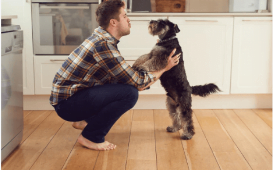 Photo of man talking to his dog