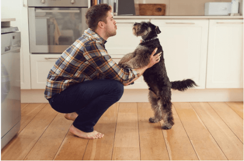 Photo of man talking to his dog